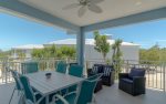 Spacious balcony overlooking the pool with plenty of seating for relaxing or outdoor dining.